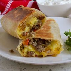 a burrito with meat and vegetables on a plate