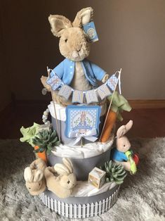 a diaper cake with an image of a rabbit on top and other toys around it