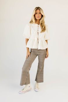 fall called + said you needed some high-waisted plaid pants. featuring a retro-inspired brown + red plaid pattern, these flared bottoms make your body look bomb. the perfect statement pants for date nights, office outfits, + everything in between; we love them dressed up with a blouse + heels, or down with a graphic tee + sneakers. burgundy // high waisted, flare leg, one bottom fly zip, back pockets paired with our moonlight blouse + kacey knit top model is 5'8" + wearing a small measurements a Flared Bottoms, Statement Pants, Plaid Trousers, Date Nights, Peplum Styles, Puff Sleeve Blouse, Plaid Pants, Office Outfits, Top Model