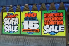 storefronts with advertisements for sale on the front and side of each building in different colors