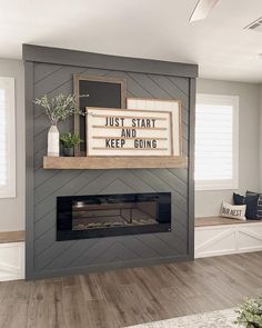 a fireplace with a sign that says just start and keep going above it on the mantle