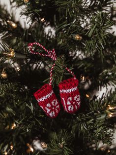 Red and white mitten ornament tied together with a red and white string and hung on a holiday tree Mitten Ornaments, Sock Knitting, Seasonal Decorations, Tree Wall, Deck The Halls, Rearview Mirror, Christmas Garland, Holiday Tree, Holiday Spirit