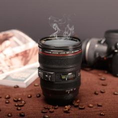 a camera lens sitting on top of a table next to coffee beans