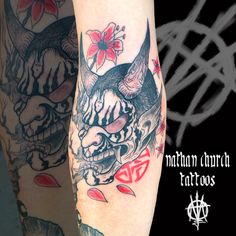 two tattoos on the legs of people with devil and demon heads in their hands, one is