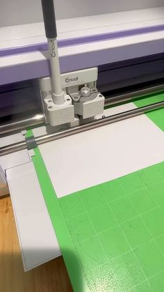 an image of a machine that is cutting paper on the floor in front of it