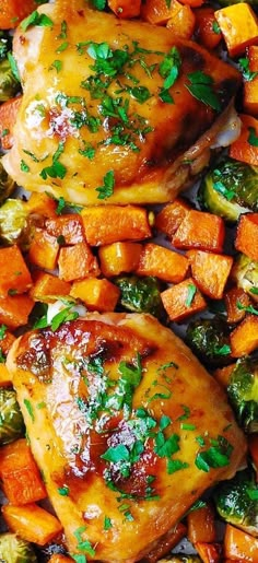 chicken, carrots and parsley on top of a bed of roasted veggies