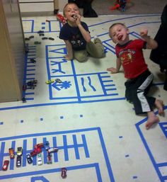 two young boys playing with toys on the floor