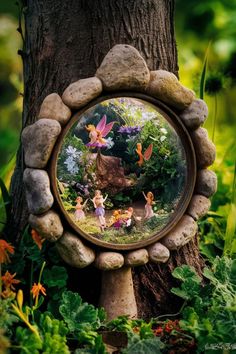 a fairy garden scene is seen through a mirror on a tree in the grass and flowers