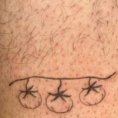 a close up of a person's leg with tattoos on it and the word tomato written in cursive writing