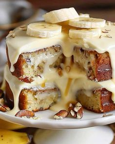 there is a cake with bananas on it and icing drizzled over the top