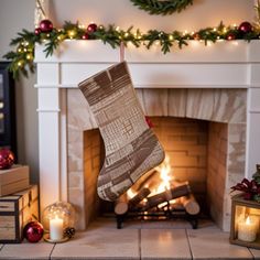 a christmas stocking hanging from a fireplace in front of a fire place with lit candles