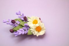 a purple and white flower with leaves on it