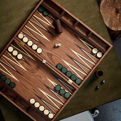 a wooden board game set up on top of a table with several pieces in it