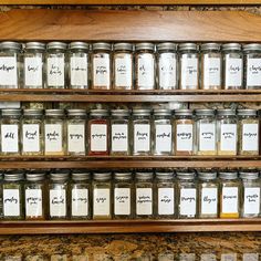 many jars with labels on them are lined up