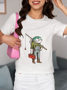 Dive into the quirky world of fishing with our unique Fish-Headed Fisherman T-Shirt! This whimsical and funny graphic tee features a fisherman with a fish head, carrying a red toolbox and a fishing rod. Perfect for fishing enthusiasts, outdoor adventurers, or anyone with a great sense of humor. We utilize the authentic Bella Canvas 3001 brand, renowned for its UNISEX design, making it one of the most sought-after shirts in the market. Prior to placing an order, kindly refer to our size chart. It Short Sleeve Fish Print T-shirt For Fishing, Graphic Print Short Sleeve T-shirt For Fishing, Casual Pre-shrunk T-shirt For Fishing, White Graphic T-shirt For Fishing, Graphic Tee T-shirt For Fishing, Graphic Tee Short Sleeve T-shirt For Fishing, Casual Crew Neck Fishing T-shirt, White Graphic Print T-shirt For Fishing, Graphic Print Crew Neck T-shirt For Fishing