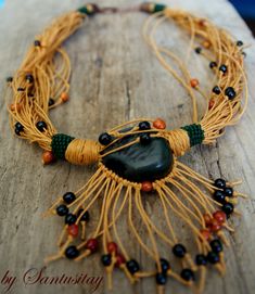 "This necklace is made from beautiful big green tagua seed and black & brown small achira seeds. I used natural waxed linen cord in yellow/mustard/ochre colour. The necklace is decorated with pieces of peyotl stich in dark green mat colour toho beads. circumference 50-53 cm Vegetal Marfil plant also known as Tagua grows mainly in the tropical forests of Colombia, Ecuador and Panama and its seeds known as \"cabeza de negro\" (black head), Coquilla (Brasil). Seeds Tagua-Coquilla before hardeni Tropical Forests, Green Mat, Black Macrame, Toho Beads, Hand Bracelet, Green Beads, Yellow Mustard, Nature Jewelry, Fabric Gifts