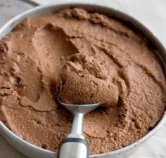 a metal bowl filled with chocolate cake batter