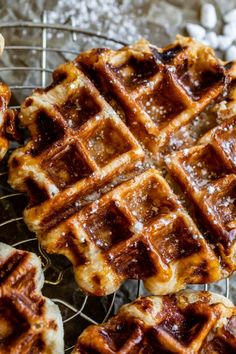 waffles on a cooling rack with powdered sugar