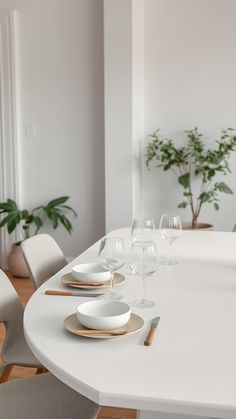 a white table topped with plates and glasses