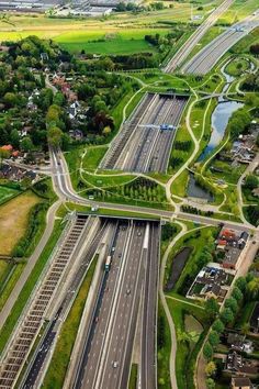 an aerial view of a highway and roadway intersection in the country side, with many lanes running parallel to each other