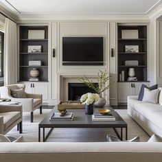 a living room filled with furniture and a flat screen tv mounted on the wall above a fireplace