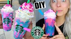 the woman is holding two starbucks drinks with pink and blue sprinkles on them