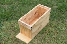 a wooden box sitting in the grass