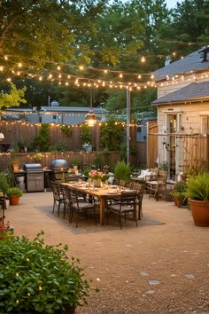 an outdoor dining area is lit up with lights and potted plants on the patio