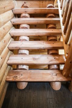 stairs made out of wooden planks in a log cabin