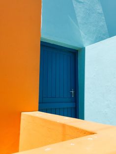 an orange and blue building with a blue door