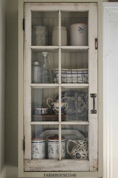 an old china cabinet is filled with dishes