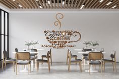 there is a coffee sign on the wall above the table in this room with many chairs