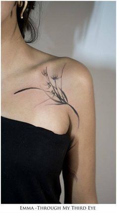 a woman with a flower tattoo on her shoulder