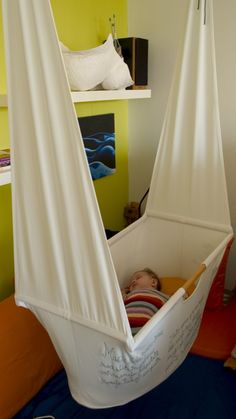 a child is laying in a hammock bed