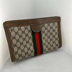 Vintage Gucci Clutch, With Velcro Closure. Brown Leather And Gucci Logo Pvc. Inside Material Is Swede. Condition Is Used, But Good. Purse Is Approx. 11 In X 7 In. Front And Back Of Clutch Are Identical. Gucci Travel Clutch Shoulder Bag, Gucci Clutch For Everyday Use, Luxury Gucci Rectangular Clutch, Gucci Clutch For Daily Use, Gucci Leather Rectangular Clutch, Gucci Beige Wallet, Beige Gucci Wallet For Everyday Use, Designer Brown Clutch For Shopping, Gucci Rectangular Wallet