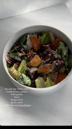 a white bowl filled with salad on top of a table