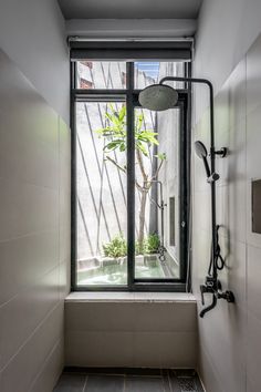 a bathroom with a window and shower head