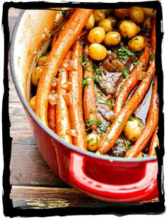 carrots and potatoes in a red pot with parsley on the side, ready to be eaten