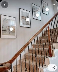 stairs with pictures on the wall above them