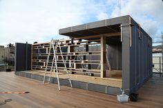 a building that is being built on top of a wooden floor