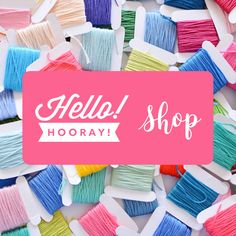 the words hello shop hooray surrounded by spools of thread