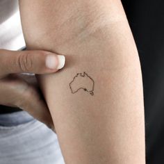 a woman's arm with a small tattoo of a koala on the side