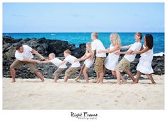 a group of people holding hands on the beach