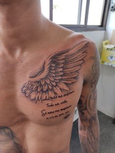 a man with tattoos on his chest has a message written in spanish and an eagle