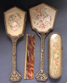 four antique spoons and two forks with flowers on them