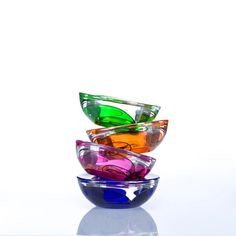 three colorful glass bowls stacked on top of each other