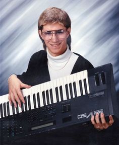 a man holding an electronic keyboard in front of his face