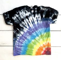 a tie - dyed shirt is hanging on the wall