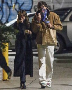 a man and woman walking down the street