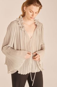 Beautiful plissé pleating creates volume and movement on this free-flowing blouse. Romantic Movement, Blouse Images, Safari Dress, Flowing Blouse, Feminine Wardrobe, Faux Shearling Coat, Tie Neck Dress, Pleated Tops, Tie Neck Tops